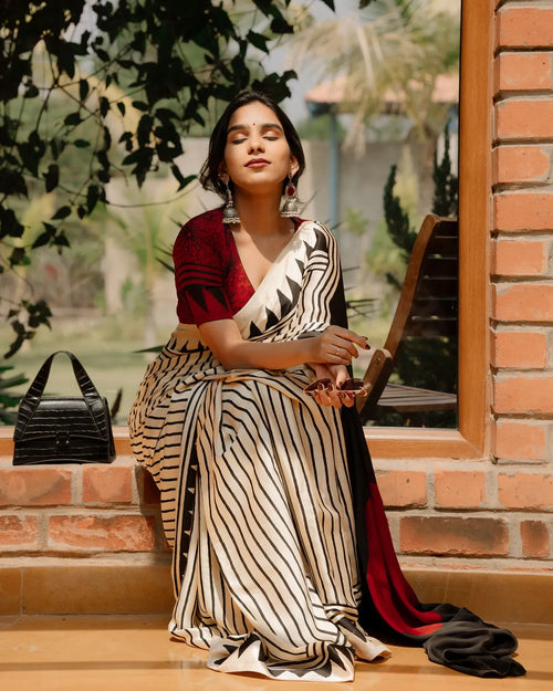 BEAUTIFULL CREAM STRIPTED SAREE WITH RED BINDI PALLU.